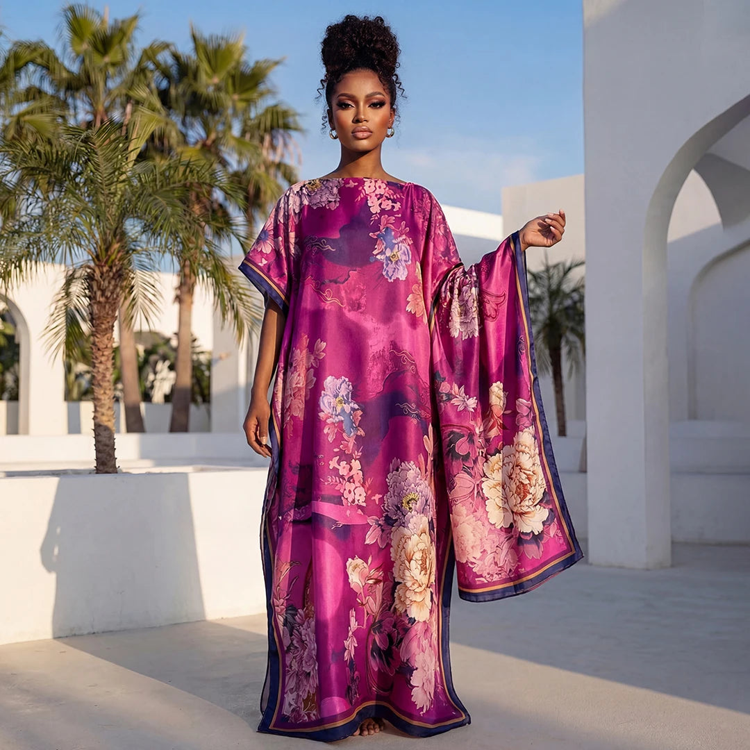 Une femme modélise un foulard floral magenta vibrant avec une bordure violette dans un cadre architectural extérieur.
