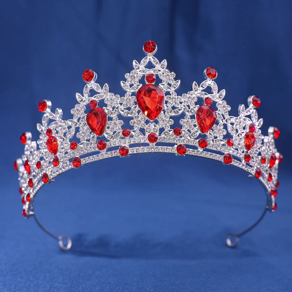 An elegant crystal rhinestone tiara and headband set featuring red gemstones.