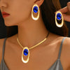 Gold and blue oval three-ring buckle necklace set worn by a woman