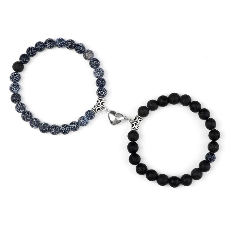 A pair of natural stone heart couple bracelets, one dark blue and one black.
