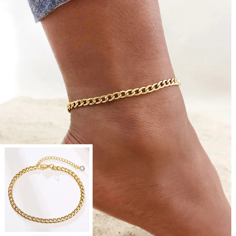 Gold stainless steel snake chain anklet worn on a woman's ankle.