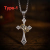 A silver crown cross necklace with gold accents displayed on a dark wooden surface.