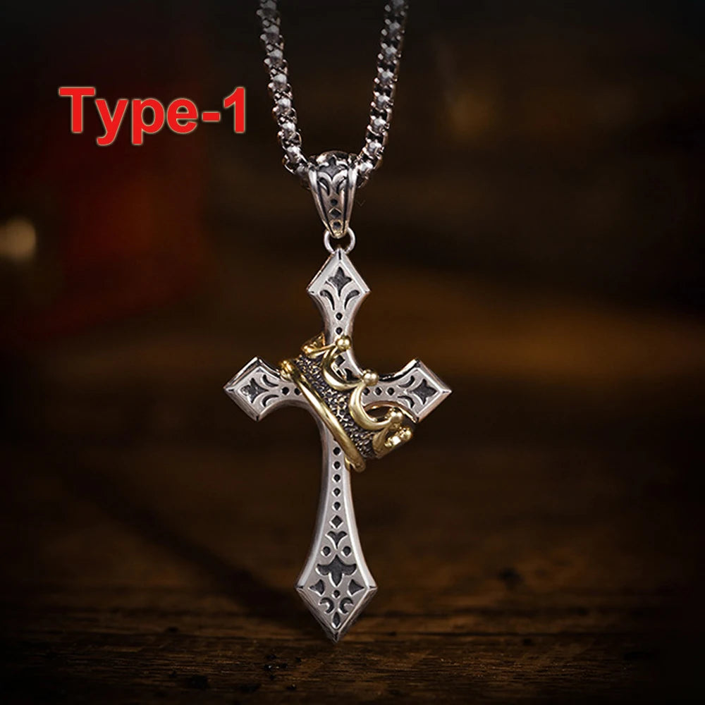 A silver crown cross necklace with gold accents displayed on a dark wooden surface.