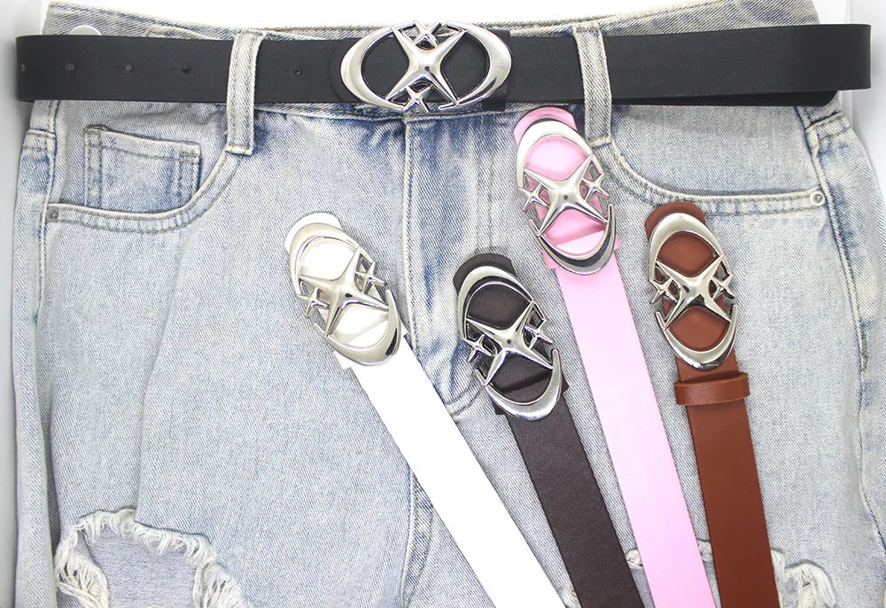 A close-up of a denim jean pocket featuring a silver moon star buckle belt and several colored leather straps.