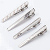Silver metal tie clips shown in various angles and styles for men's neckties