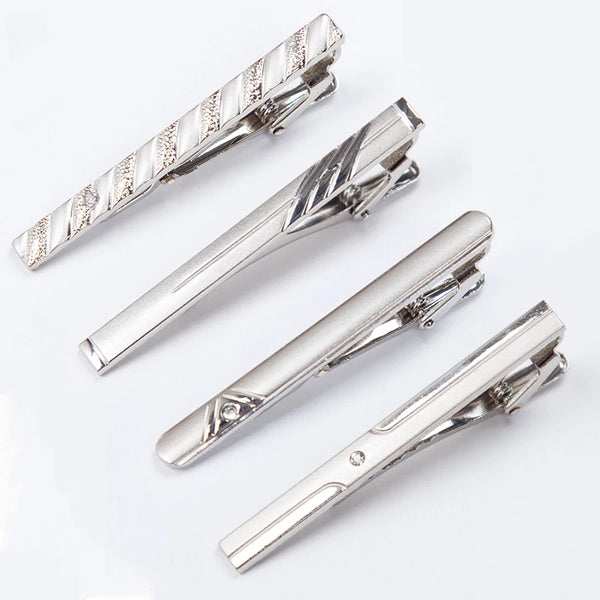 Silver metal tie clips shown in various angles and styles for men's neckties