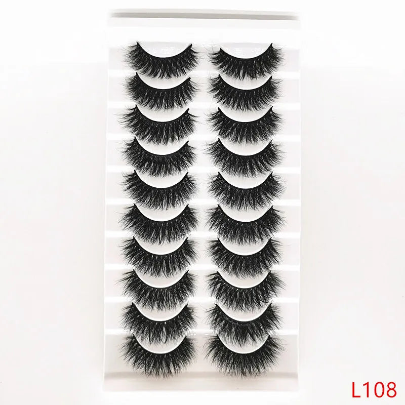 A display of dramatic mink false eyelashes arranged in rows on a white background.