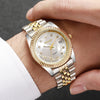 A close-up of a silver and gold rhinestone quartz wristwatch worn on a person's wrist.