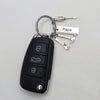 A black multi-tool keychain set with a loop and a tag reading Papa