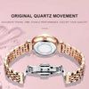 A close-up of a rose gold stainless steel quartz ladies wristwatch with a leather strap displayed against a pink background.