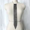 A long, silver crystal rhinestone sequin necklace displayed on a mannequin's neck.