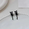 Pair of black cat stud earrings featuring a cute, detailed cat design.
