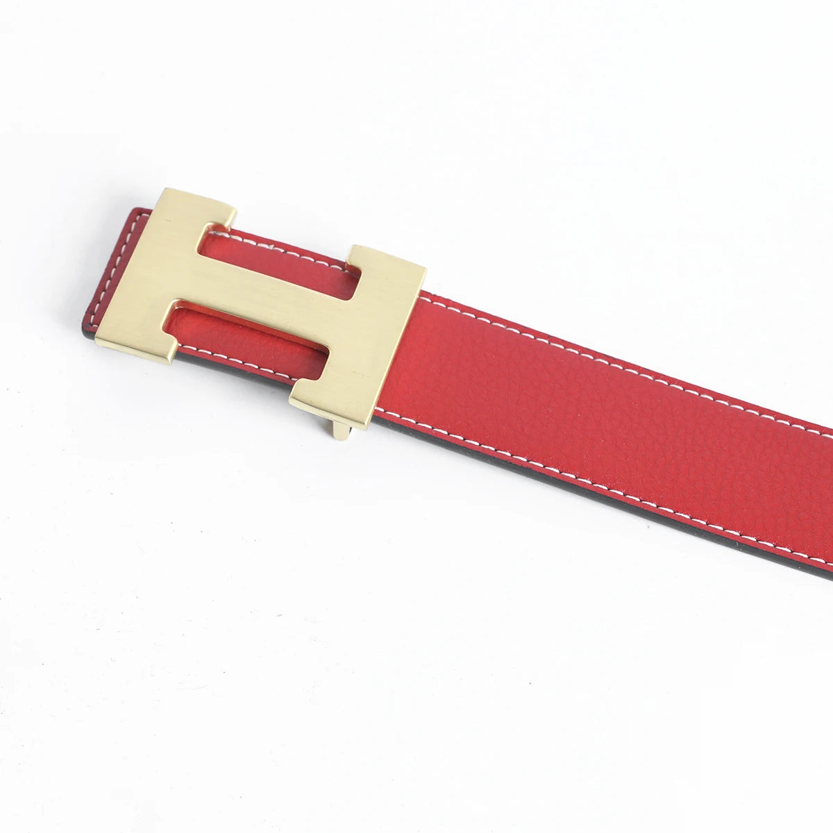 A red genuine leather dress belt with a brass buckle shown diagonally.