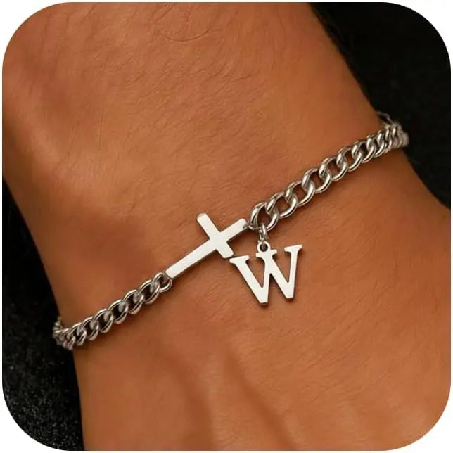 A close-up of a silver stainless steel cross Cuban chain bracelet worn on a wrist.