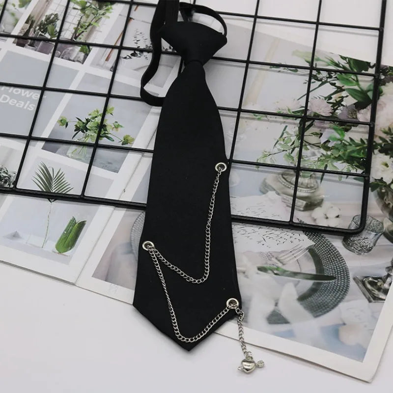 A black classic chain necktie is displayed against a grid background of photographic prints.