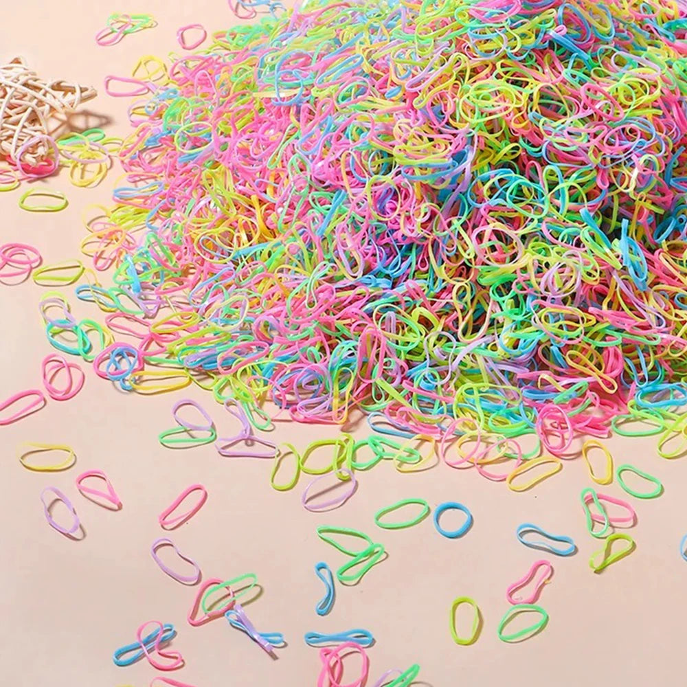 A pile of colorful disposable rubber hair ties in various bright colors like pink, green, blue, and yellow.