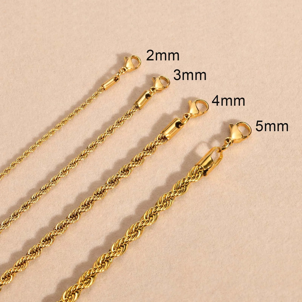 A set of dainty gold rope chain necklaces with varying lengths and jump rings.