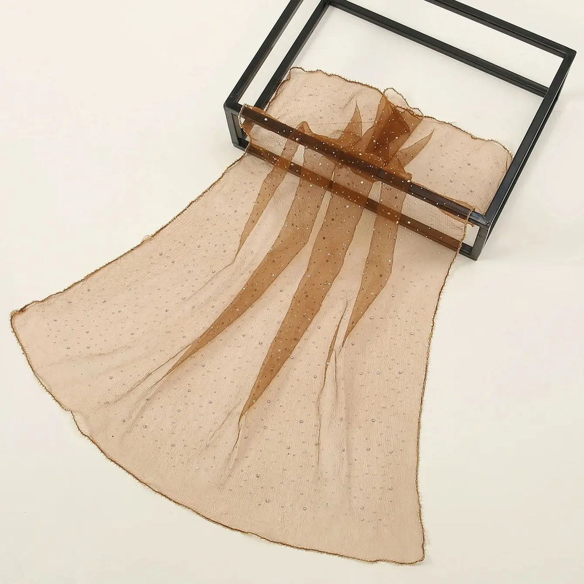 Beige, durchscheinender Mode-Hijab mit goldenen Details in einem schwarzen Rahmen.