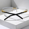 A pair of black rectangular sunglasses with gold accents displayed inside a white box.