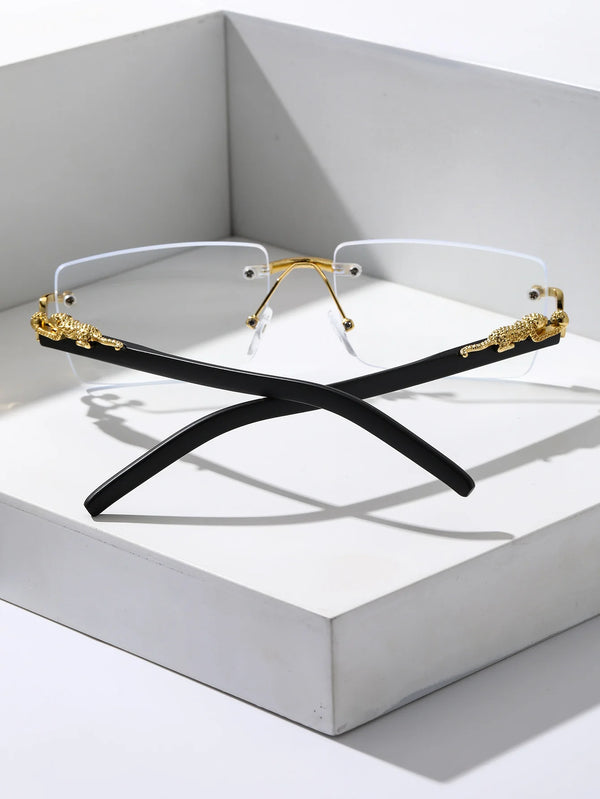 A pair of black rectangular sunglasses with gold accents displayed inside a white box.