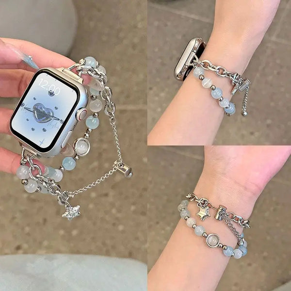 A close-up of a handmade transparent blue double chain watch strap worn on a wrist.