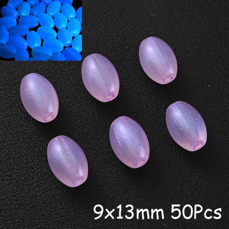 A collection of translucent purple glow-in-the-dark acrylic beads scattered on a black surface.