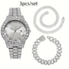 Un ensemble de trois bijoux en chaîne cubaine argentés, comprenant une montre et deux colliers.