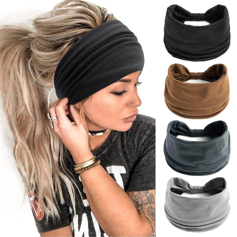 A woman wearing a black boho knot headwrap hair band while posing with long blonde hair.