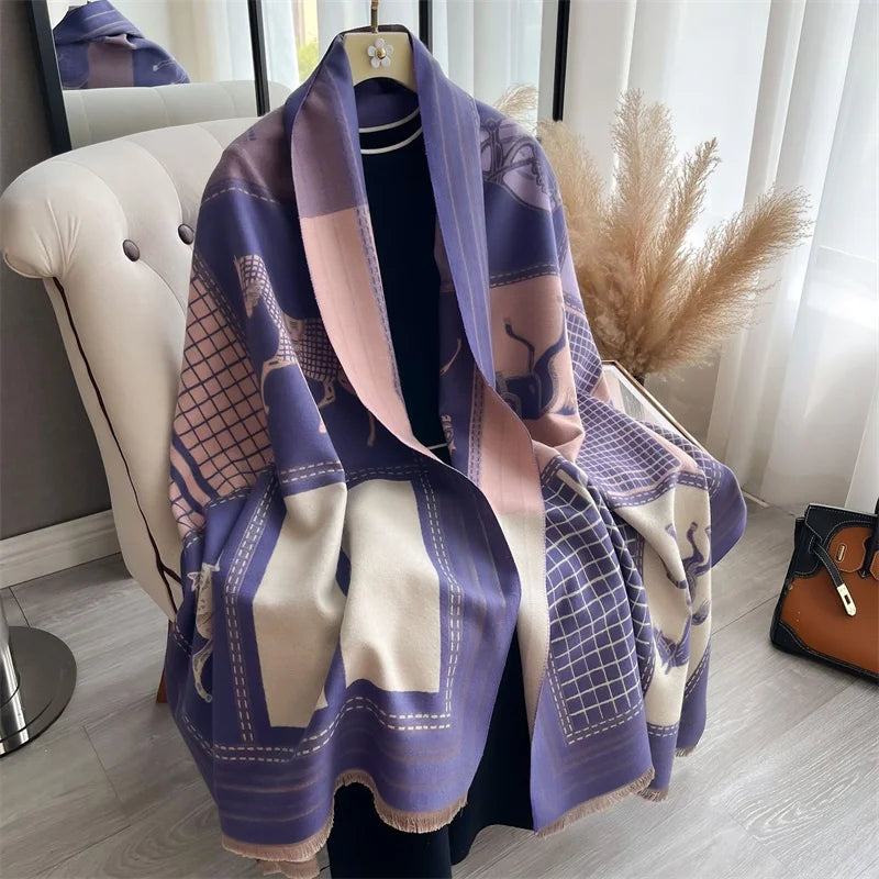 A purple and beige plaid cashmere feel scarf draped on a hanger against a bright background.