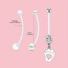 A set of silver belly button rings featuring a 14 gauge chain and pearl-like beads.