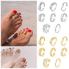 A collection of adjustable open toe rings and various silver and gold rings displayed on a hand.