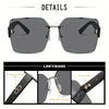 Une paire de grandes lunettes sans monture à dégradé avec des montures noires et des verres teintés, vue en détail.
