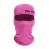 Una mascarilla de rostro balaclava rosa brillante con texto negro que dice Shiesty