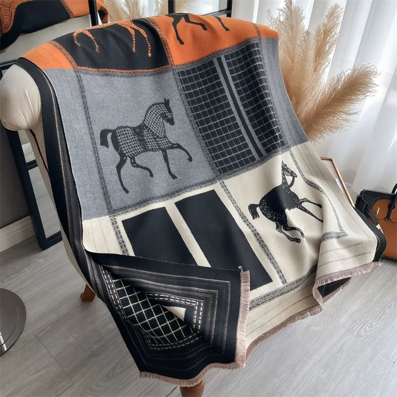 A luxury plaid cashmere feel scarf and shawl wrap featuring black, gray, and orange patterns with horse motifs.