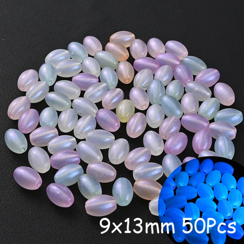 A collection of luminous glow-in-the-dark acrylic beads in various shades of pink, purple, and white on a black background.