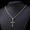 Silver cross amulet necklace displayed on a black display stand