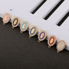 A line of gold-toned rosary connectors featuring oval beads in pink, blue, purple, and red with gold accents.