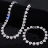 A set of sparkling heart rhinestone necklaces and bracelets displayed on a black surface.