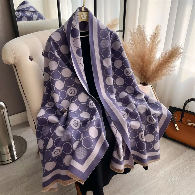 A purple and white plaid cashmere feel scarf draped over a black garment, displayed in a bright room.
