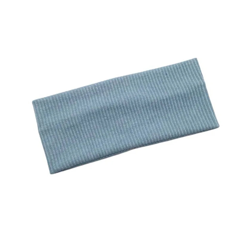 Light blue knitted sports headband designed for yoga and gym activities.