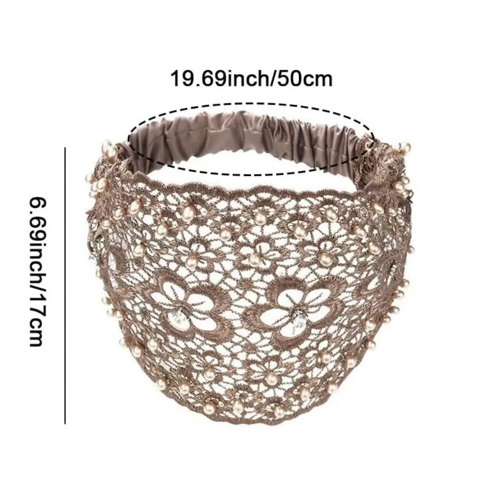 A beige crystal pearl floral beaded headband with a satin band, shown flat.