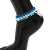 Boho multi-layer anklet charm set featuring multiple strands of turquoise and white beads on a black mannequin leg.