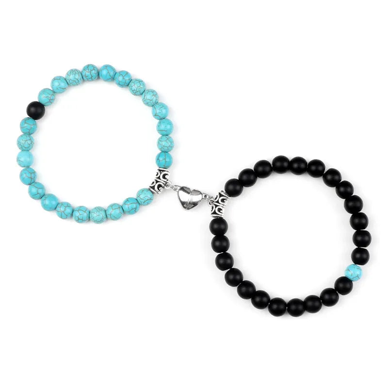 A pair of natural stone heart couple bracelets, one turquoise and one black, displayed against a white background.