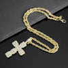 Gold chain necklace with a sparkling rhinestone cross pendant displayed on a black surface.