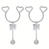A pair of silver heart dangle non-piercing nipple rings with cubic zirconia stones.