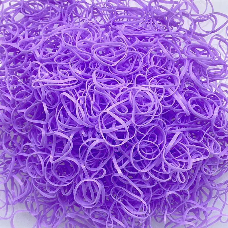 A pile of purple disposable hair scrunchies for ponytail holders.