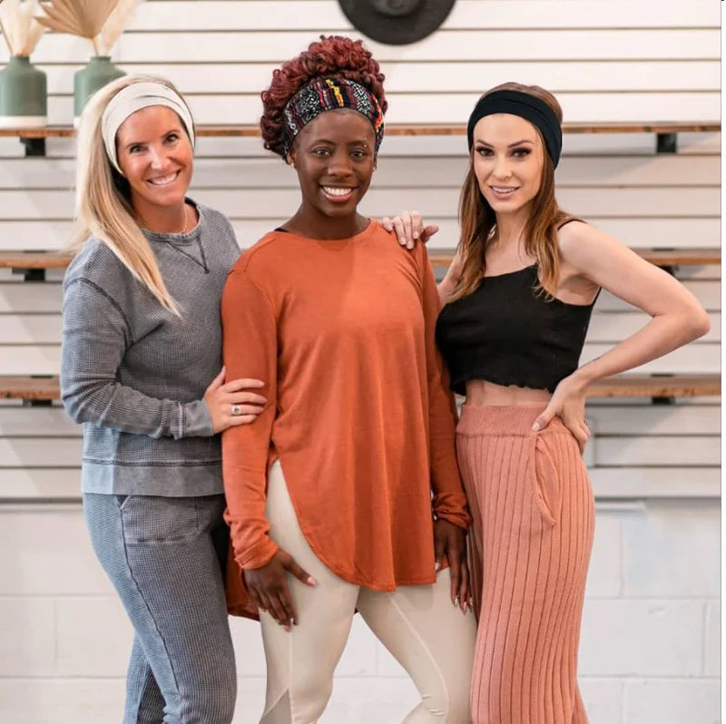 Three women modeling bohemian pattern headbands for yoga and sports