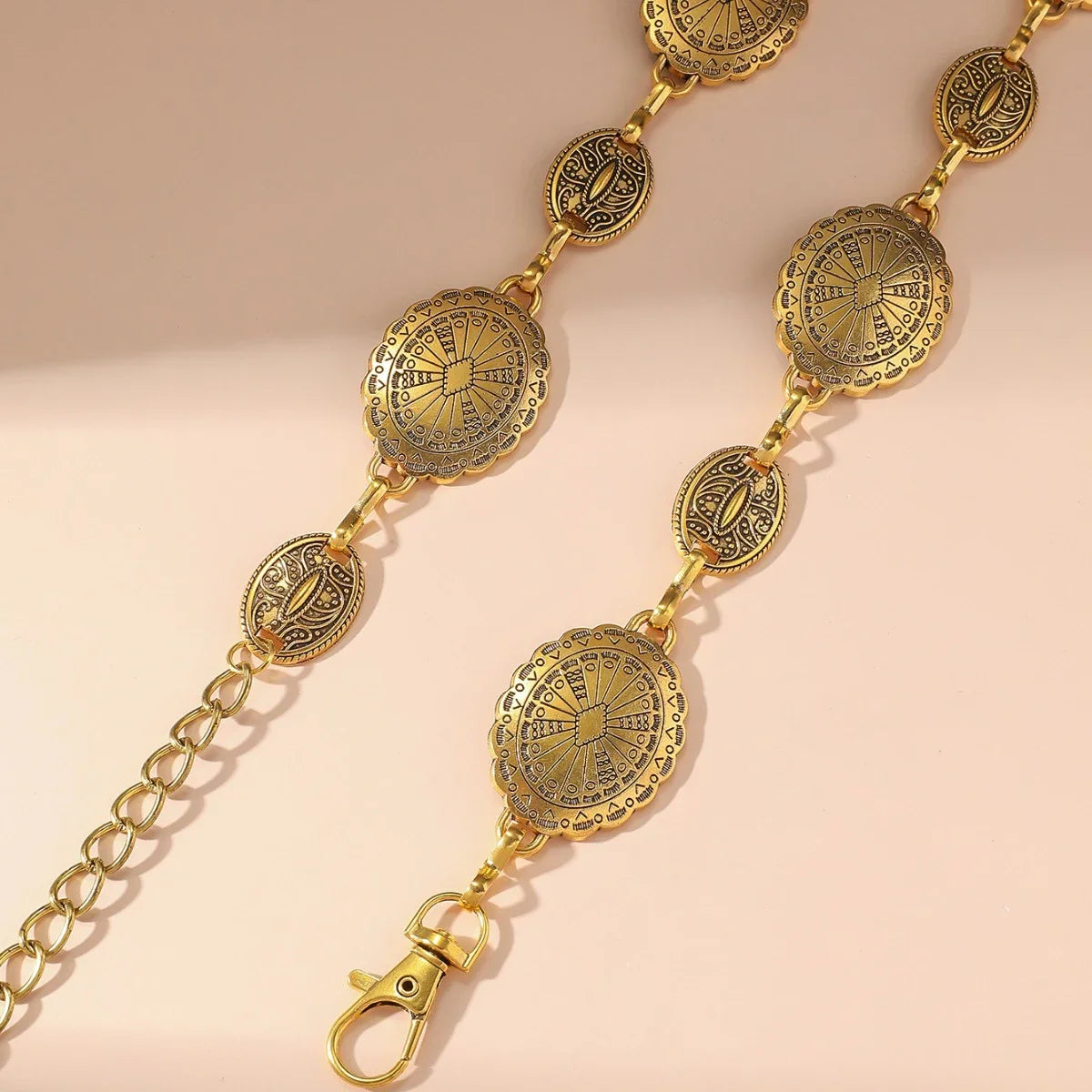 Cadena de cintura ovalada de metal dorado vintage para mujeres con intrincados detalles y sección de eslabones.