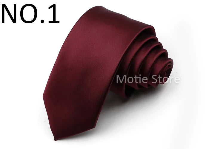 A dark burgundy satin neck tie folded and displayed on a white background.