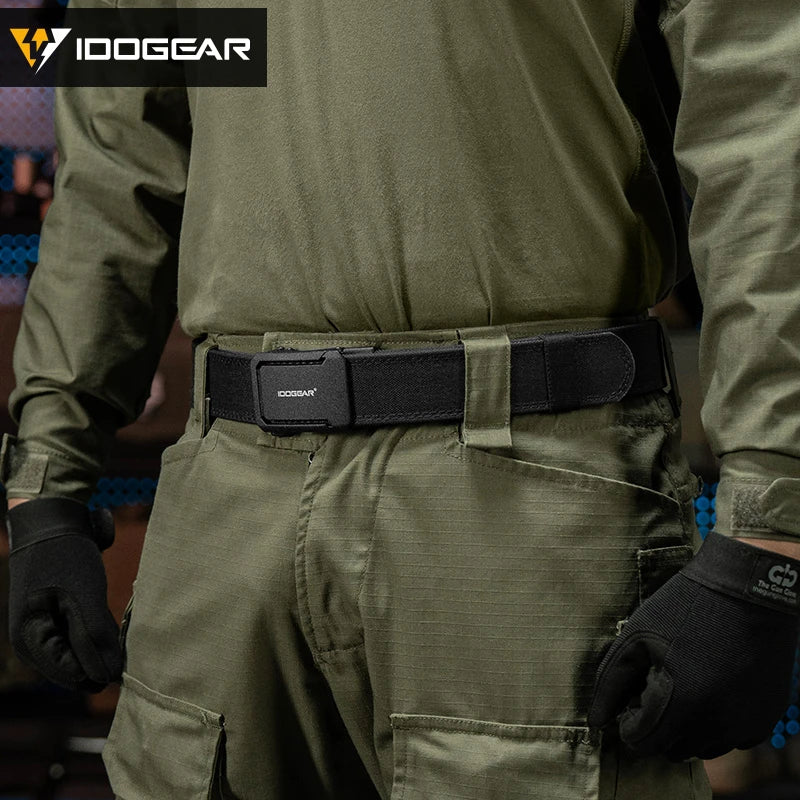 A close-up of a tactical nylon belt with a ratchet buckle worn around the waist of a person in olive green clothing.